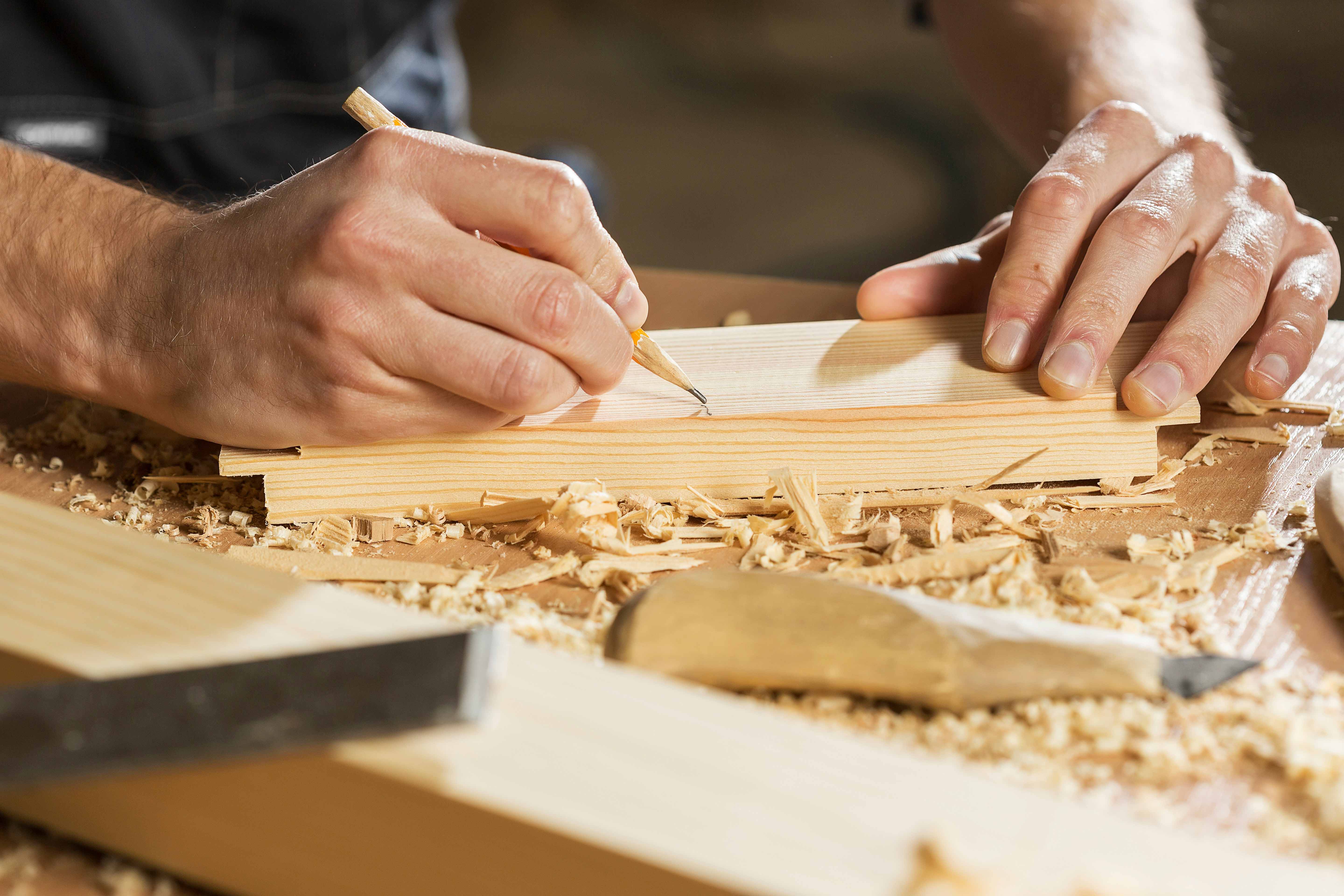 Skilled joiner marking wood for precision craftsmanship